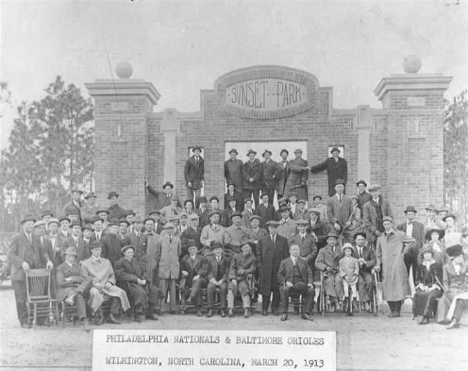 A photo of the 1913 Philadelphia Nationals & Baltimore Orioles posing in front of the entrance to Sunset Park in Wilmington NC